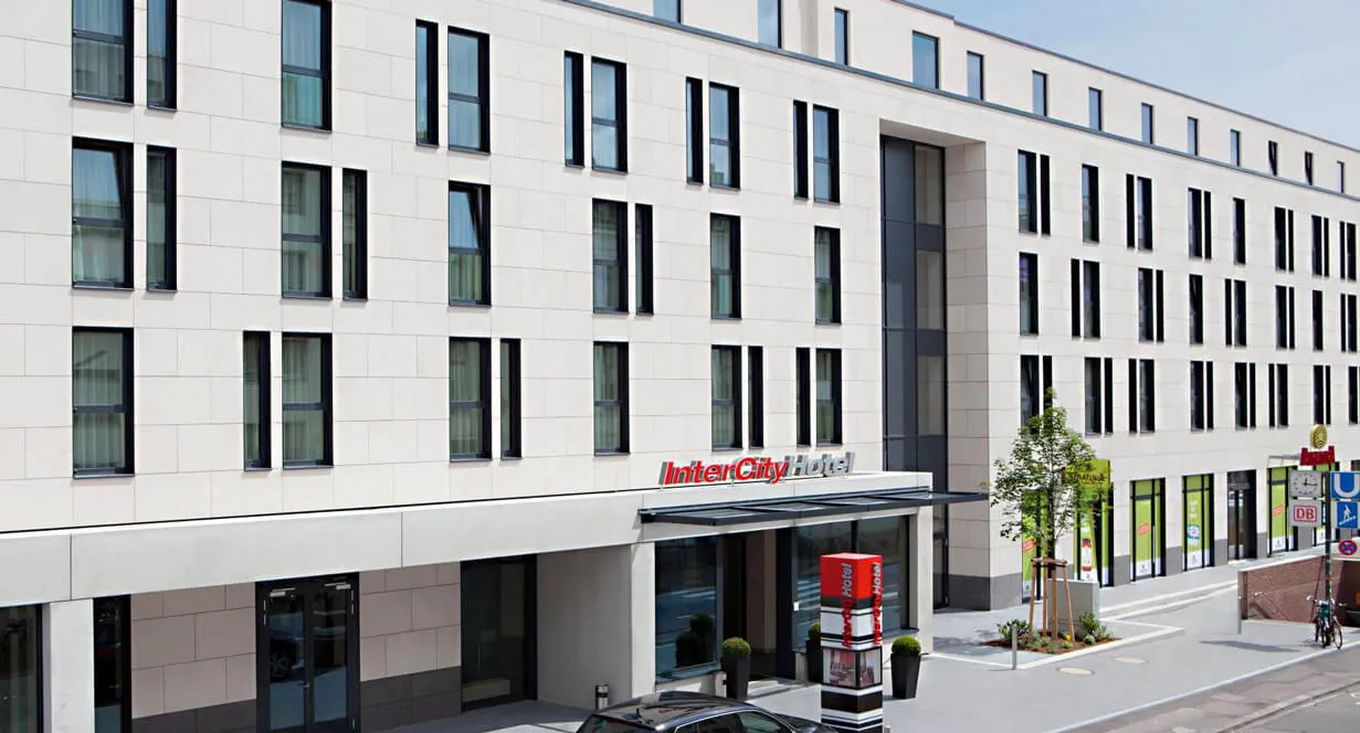 White hotel building by day with entrance