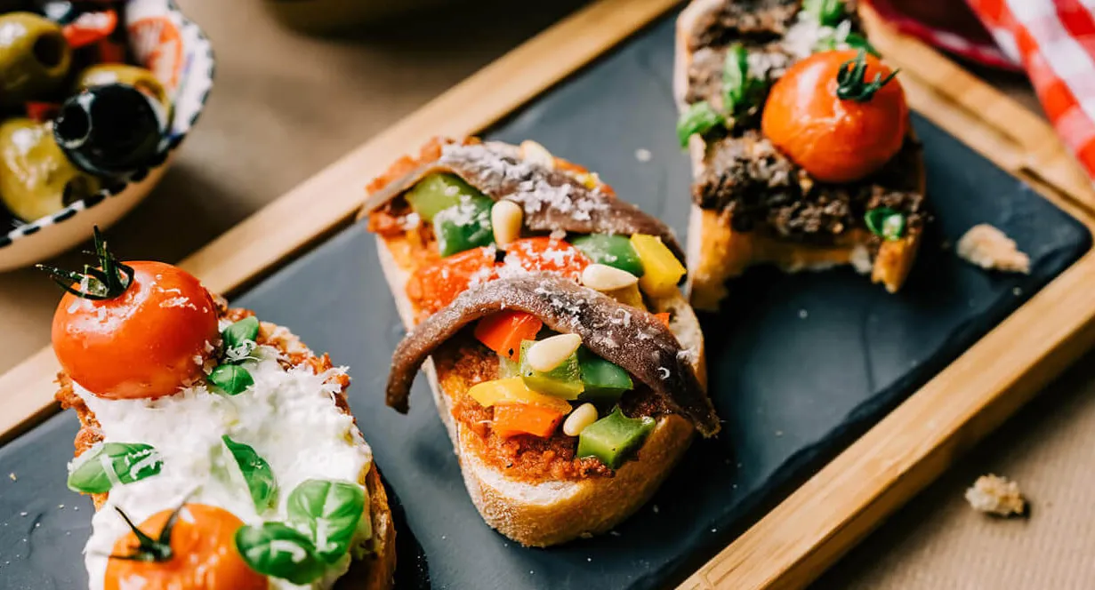 Starter plate with triology of bruschetta and olives