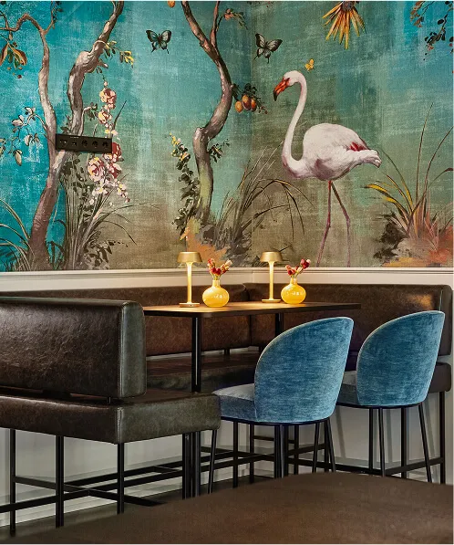 Sitting area with colourful printed wallpaper