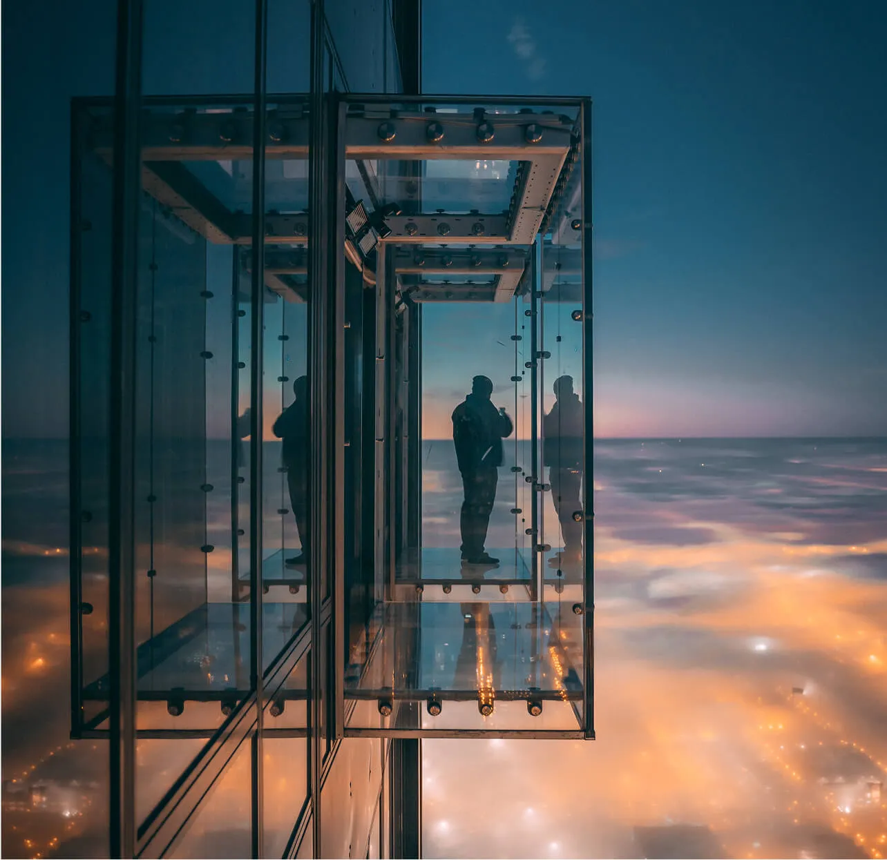 Skywalk out of building by night with city view and fog
