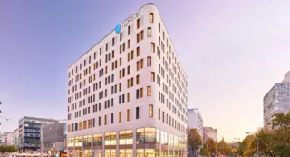 Big white modern hotel building with view into the sky