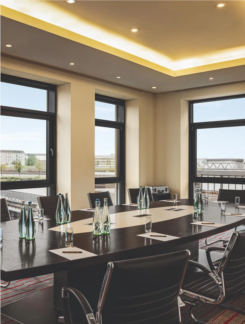 Boardroom table with leather chairs and outside view
