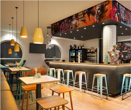 Modern hotel bar with high chairs and tables