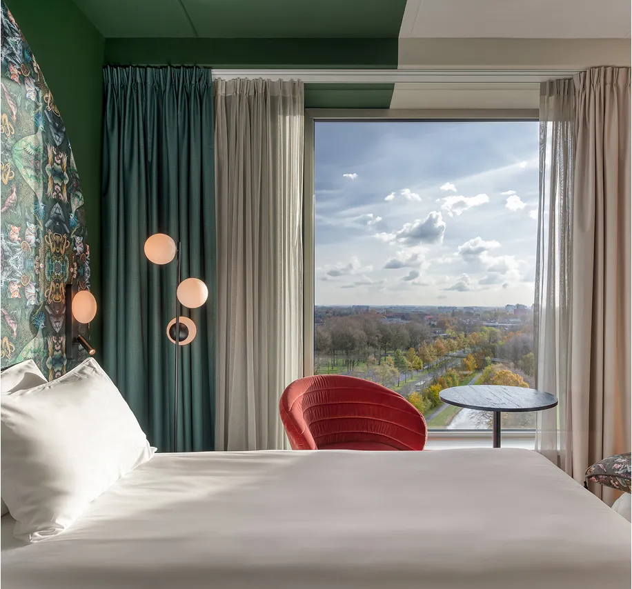 View on hotelbed with view into green out of window