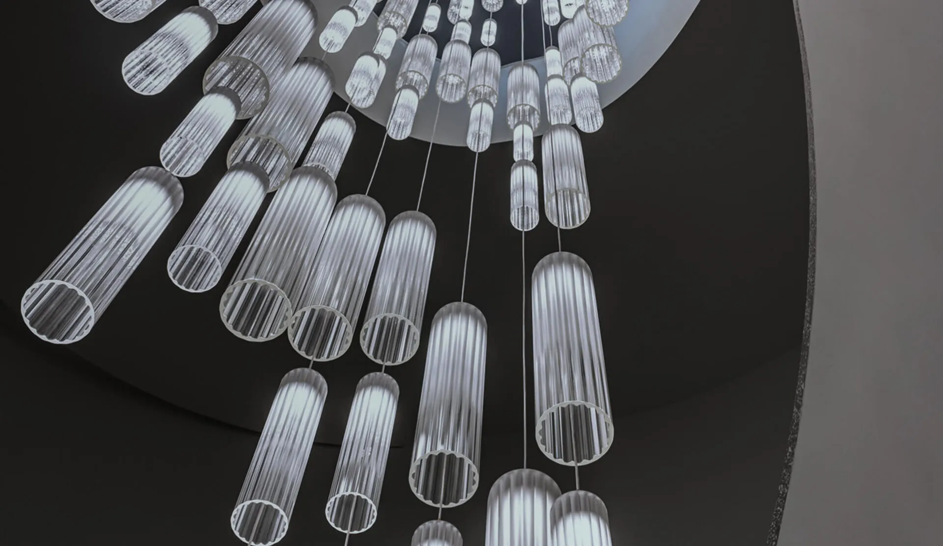 Vertical view on white glass light shields of a chandelier